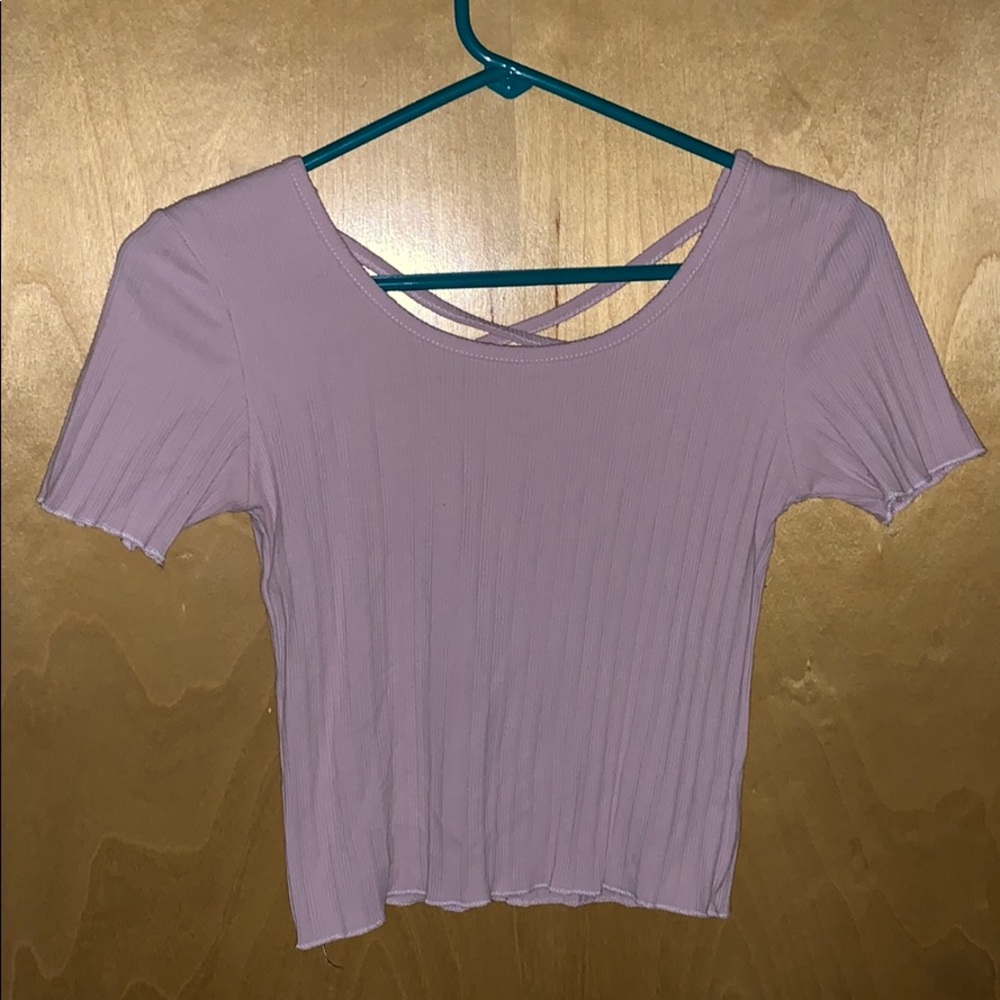 Pink crop top. Cross in back. Very nice quality.